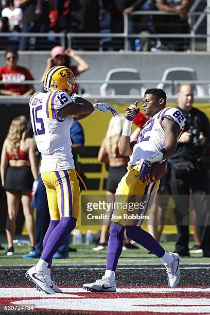Chark of the LSU Tigers celebrates with Malachi Dupre after a 39-yard reception against the Louisville Cardinals to set up a touchdown in the second...