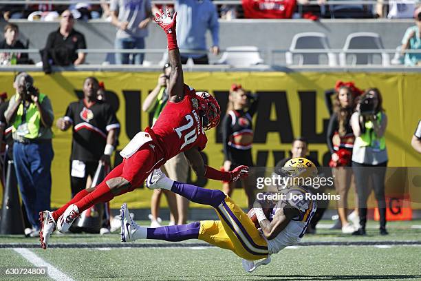 Chark of the LSU Tigers makes a 39-yard reception behind Zykiesis Cannon of the Louisville Cardinals to set up a touchdown in the second quarter of...