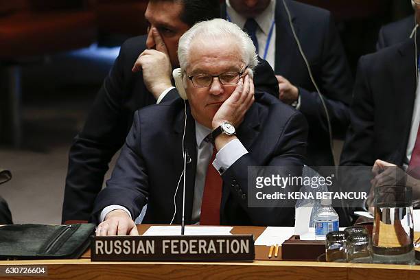 Russian Ambassador to the UN Vitaly Churkin listens at the UN Security Council which voted on a Russian-Turkish peace plan for Syria, on December 31...
