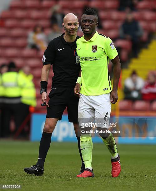 Gabriel Zakuani of Northampton Town is helped from the pitch by Referee Darren Drysdale during the Sky Bet League One match between Sheffield United...