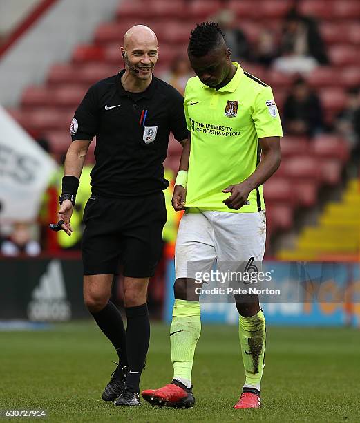 Gabriel Zakuani of Northampton Town is helped from the pitch by Referee Darren Drysdale during the Sky Bet League One match between Sheffield United...