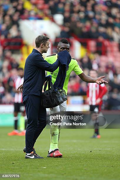 Gabriel Zakuani of Northampton Town is helped from the pitch by physio Anders Braastad with a nose bleed during the Sky Bet League One match between...