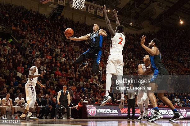 Jayson Tatum of the Duke Blue Devils goes to the basket against Khadim Sy the Virginia Tech Hokies at Cassell Coliseum on December 31, 2016 in...