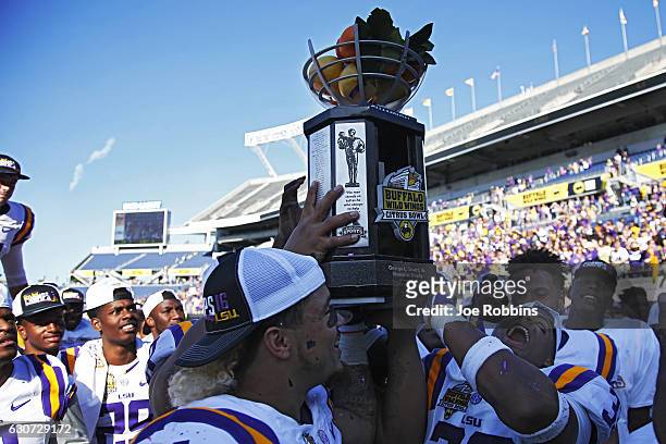Tigers players celebrate after defeating the Louisville Cardinals 29-9 in the Buffalo Wild Wings Citrus Bowl at Camping World Stadium on December 31,...