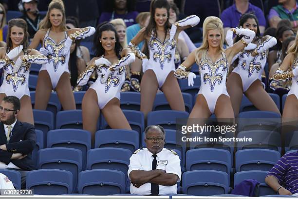 Bus driver for the LSU Tigers watches the game as the Golden Girls dance team dances behind him in the seats during the 2016 Buffalo Wild Wings...