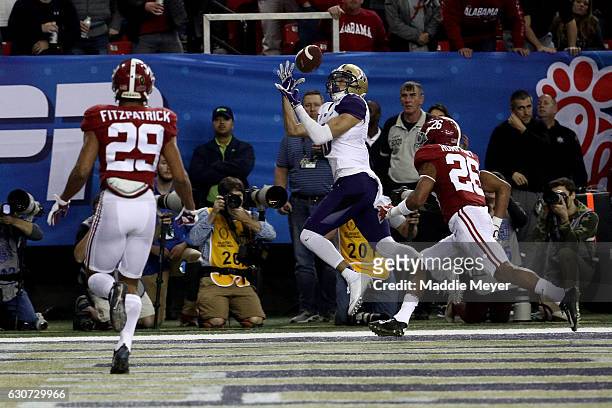 Dante Pettis of the Washington Huskies scores a touch down during the 2016 Chick-fil-A Peach Bowl at the Georgia Dome on December 31, 2016 in...
