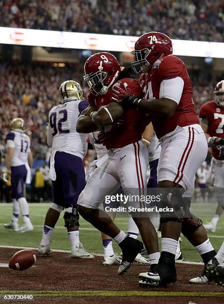 Bo Scarbrough and Cam Robinson of the Alabama Crimson Tide celebrate during the 2016 Chick-fil-A Peach Bowl at the Georgia Dome on December 31, 2016...