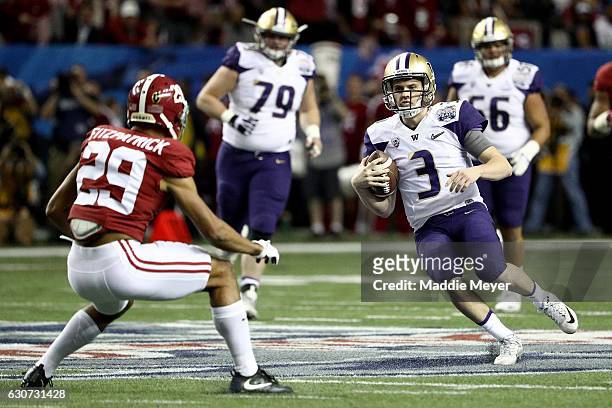Jake Browning of the Washington Huskies runs the ball during the 2016 Chick-fil-A Peach Bowl at the Georgia Dome on December 31, 2016 in Atlanta,...