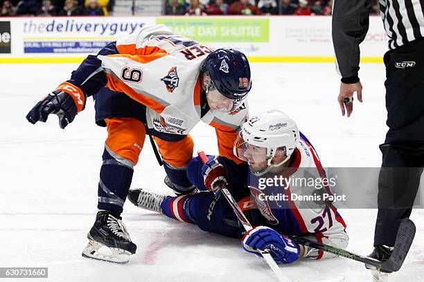 Forward Jack Phibbs of the Flint Firebirds battles against forward Hayden McCool of the Windsor Spitfires on December 31, 2016 at the WFCU Centre in...