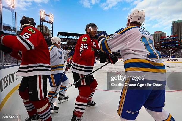 Grant Mulvey of the Chicago Blackhawks Alumni Team and Adam Oates of the St. Louis Blues Alumni Team get into a scuffle during the Alumni Game as...