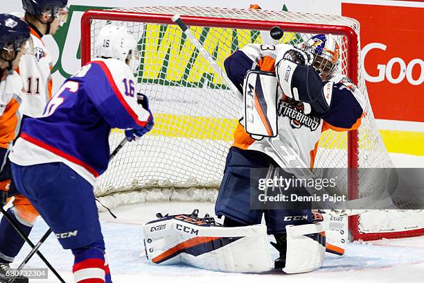 Goaltender Garrett Forrest of the Flint Firebirds makes a blocker save on a shot from forward Chris Playfair of the Windsor Spitfires on December 31,...