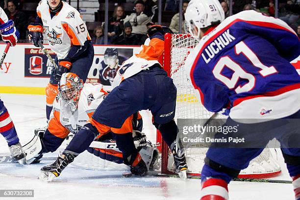 Forward Aaron Luchuk of the Windsor Spitfires fires a goal against goaltender Garrett Forrest of the Flint Firebirds on December 31, 2016 at the WFCU...