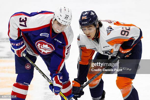 Forward Kole Sherwood of the Flint Firebirds battles on a faceoff against forward Graham Knott of the Windsor Spitfires on December 31, 2016 at the...