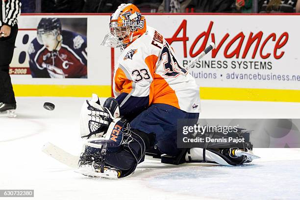 Goaltender Garrett Forrest of the Flint Firebirds makes a stick save on a shot from the Windsor Spitfires on December 31, 2016 at the WFCU Centre in...