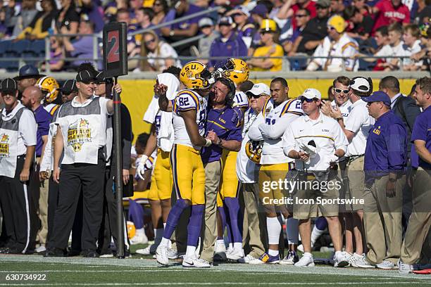 Tigers wide receiver D.J. Chark distracts his Head Coach Ed Ogerson with an embrace to allow his teammates to setup for the gatorade bath during the...