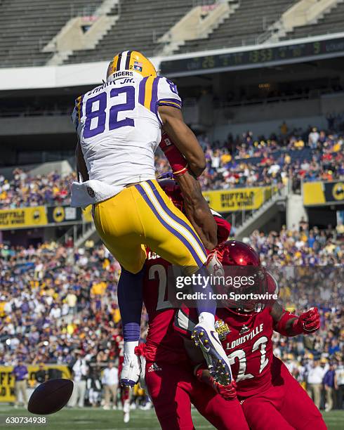 Tigers wide receiver D.J. Chark is interfered with by University of Louisville Cardinals cornerback Zykiesis Cannon during the Citrus Bowl game...