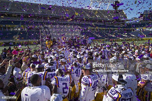 The LSU Tigers celebrate their Citrus Bowl game victory against the Louisville Cardinals on December 31 at Camping World Stadium in Orlando, FL. LSU...