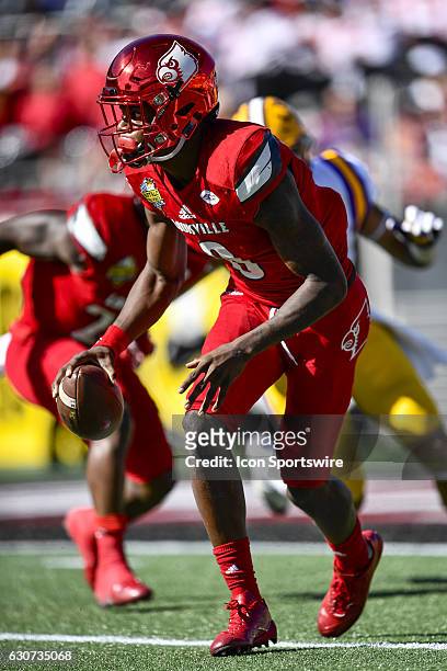 University of Louisville Cardinals quarterback Lamar Jackson scrambles to his left for a short gain during the Citrus Bowl game between the...