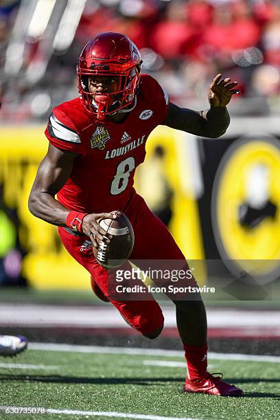 University of Louisville Cardinals quarterback Lamar Jackson scrambles to his left for a short gain during the Citrus Bowl game between the...