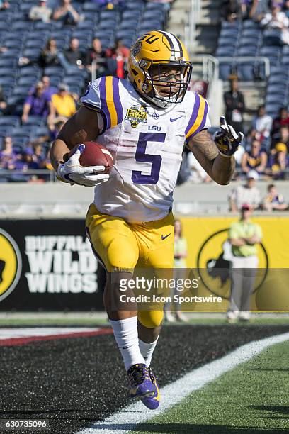 Tigers running back Derrius Guice carries the ball during the Citrus Bowl game between the Louisville Cardinals and the LSU Tigers on December 31 at...