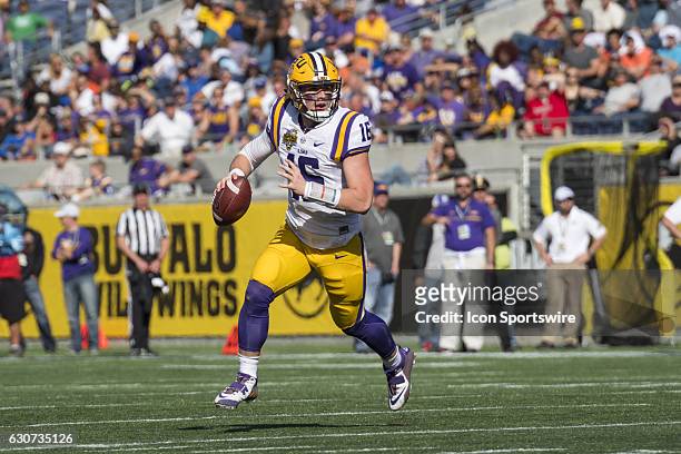 Tigers quarterback Danny Etling rolls right during the Citrus Bowl game between the Louisville Cardinals and the LSU Tigers on December 31 at Camping...