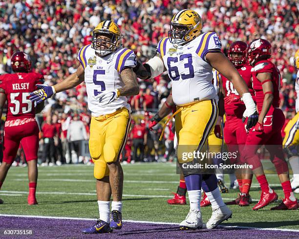 Tigers running back Derrius Guice celebrates his first down run with teammate K.J. Malone during the Citrus Bowl game between the Louisville...