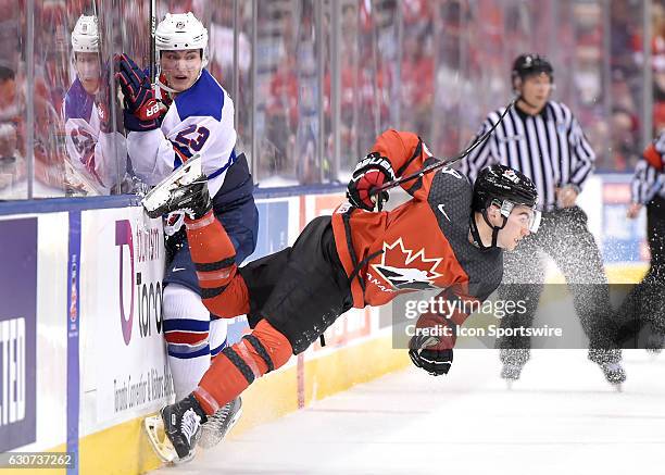 Forward Kieffer Bellows knocks down Canada forward Dillon Dube during the World Junior Hockey Championships on December 31 at the Air Canada Centre.