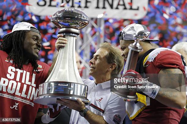 Alabama Crimson Tide defensive lineman Da'Shawn Hand , head coach Nick Saban and linebacker Ryan Anderson hold the trophies at the conclusion of the...