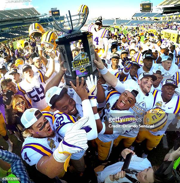 Players celebrate a 29-9 win against Louisville in the Buffalo Wild Wings Citrus Bowl at Camping World Stadium in Orlando, Fla., on Saturday, Dec....