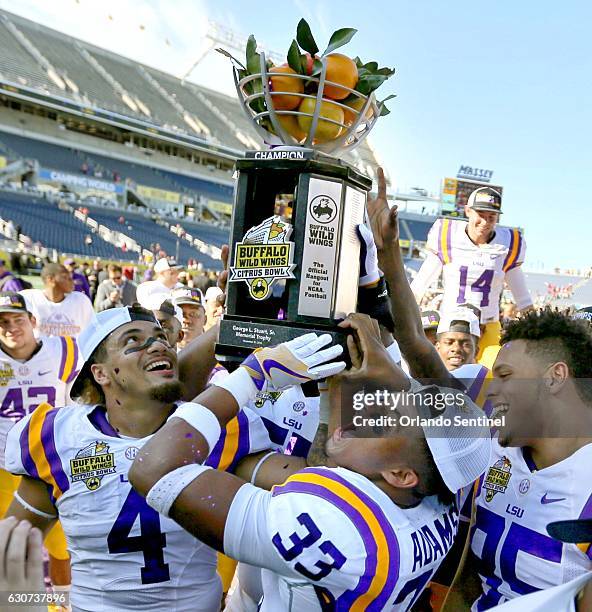 Players celebrate a 29-9 win against Louisville in the Buffalo Wild Wings Citrus Bowl at Camping World Stadium in Orlando, Fla., on Saturday, Dec....