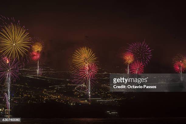 Fireworks light up the sky above Funchal Bay, Madeira Island, to celebrate the arrival of the New Year on January 1, 2017 in Funchal, Madeira,...