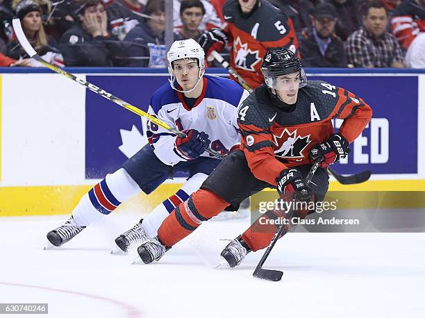 Jack Roslovic of Team USA chases after Matt Barzal of Team Canada during a preliminary round game in the 2017 IIHF World Junior Hockey Championship...