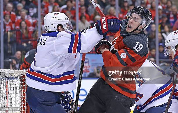 Casey Fitzgerald of Team USA slams into Pierre-Luc Dubois of Team Canada during a preliminary round game in the 2017 IIHF World Junior Hockey...