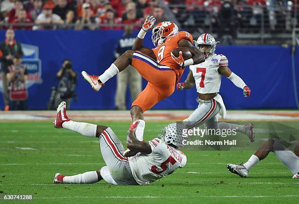 Wayne Gallman of the Clemson Tigers is upended by Raekwon McMillan of the Ohio State Buckeyes during the first half of the 2016 PlayStation Fiesta...
