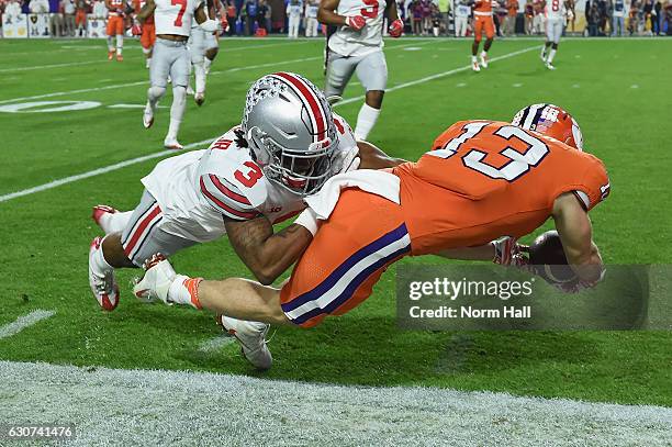 Hunter Renfrow of the Clemson Tigers is hit by Damon Arnette of the Ohio State Buckeyes during the first half of the 2016 PlayStation Fiesta Bowl at...