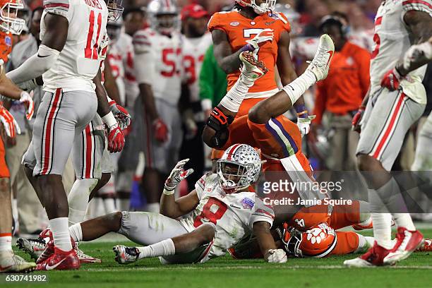 Gareon Conley of the Ohio State Buckeyes upends Deshaun Watson of the Clemson Tigers during the second half of the 2016 PlayStation Fiesta Bowl at...