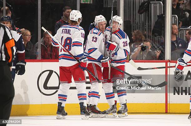 Jimmy Vesey of the New York Rangers celebrates a goal against the Colorado Avalanche with teammates Marc Staal and Kevin Hayes at the Pepsi Center on...