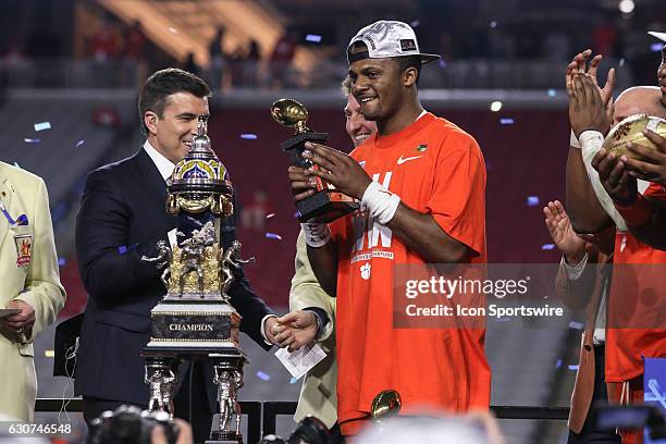 Clemson Tigers quarterback Deshaun Watson holds the offensive MVP trophy after the Playstation Fiesta Bowl college football game between the Ohio...