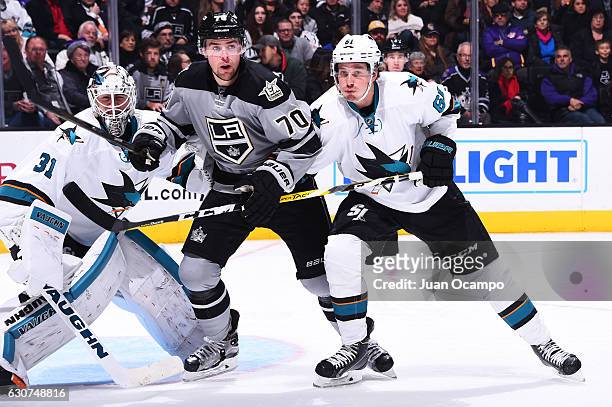 Tanner Pearson of the Los Angeles Kings battles in front of the net against Justin Braun, and Martin Jones of the San Jose Sharks during the game on...