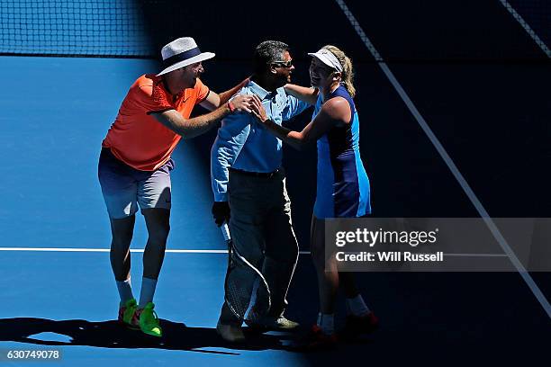 Coco Vandeweghe and Jack Sock of the United States congratulate one of the line refs after being invited to play during the mixed doubles match...