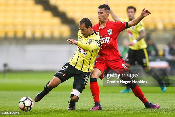 Andrew Durante of the Phoenix clears the ball under pressure from Sergio Guardiola of Adelaide United during the round 13 A-League match between...