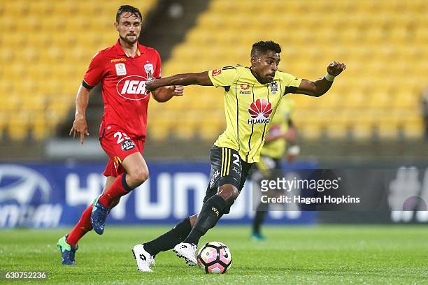 Roy Krishna of the Phoenix makes a break from James Holland of Adelaide United during the round 13 A-League match between Wellington Phoenix and...