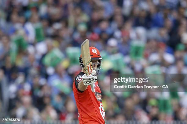 Cameron White of the Melbourne Renegades raises his bat after scoring 50 runs during the Big Bash League match between the Melbourne Stars and...