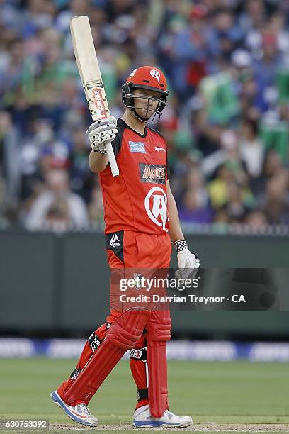 Cameron White of the Melbourne Renegades raises his bat after scoring 50 runs during the Big Bash League match between the Melbourne Stars and...