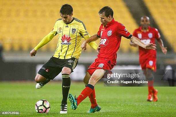 Gui Finkler of the Phoenix holds off the defence of Isaias of Adelaide United during the round 13 A-League match between Wellington Phoenix and...