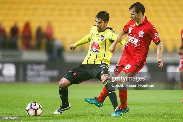 Gui Finkler of the Phoenix holds off the defence of Isaias of Adelaide United during the round 13 A-League match between Wellington Phoenix and...