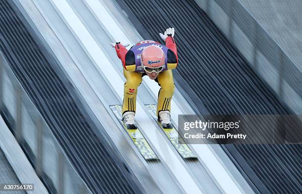 Severin Freund of Germany soars through the air during his practice jump on Day 2 of the 65th Four Hills Tournament ski jumping event on January 1,...