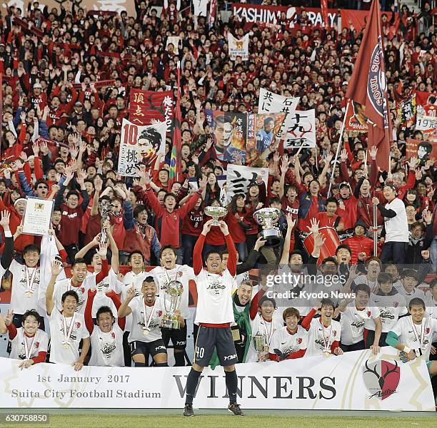 Players and supporters of Kashima Antlers celebrate after defeating Kawasaki Frontale in the Emperor's Cup final at Suita Stadium in Suita, Osaka...