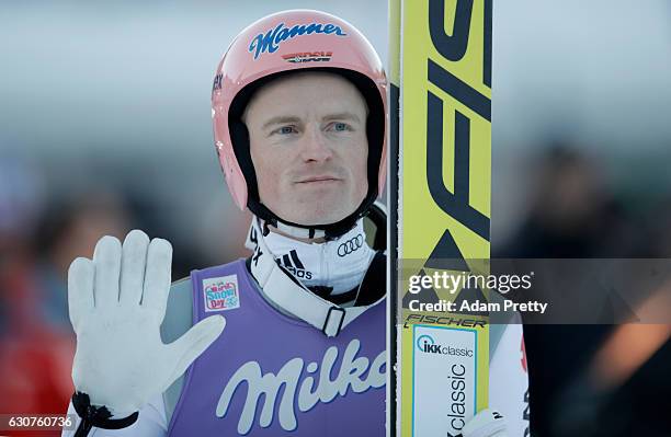 Severin Freund of Germany gestures after his final competition jump on Day 2 of the 65th Four Hills Tournament ski jumping event on January 1, 2017...