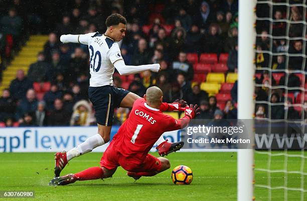 Dele Alli of Tottenham Hotspur shoots past Heurelho Gomes of Watford as he scores their fourth goal during the Premier League match between Watford...